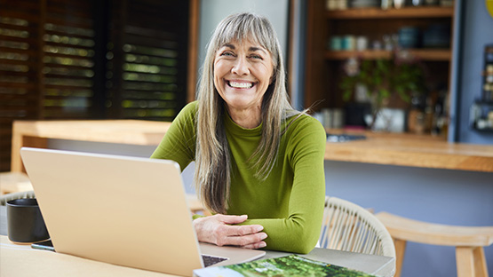 A person on a computer logs in to the member portal.