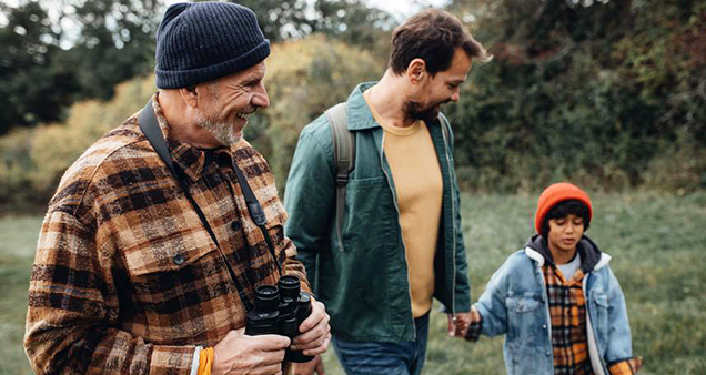 Senior, adult, and child walking