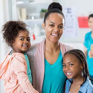 Mother standing with two daughters