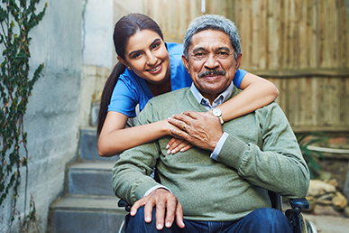 Healthcare worker hugging elderly gentleman