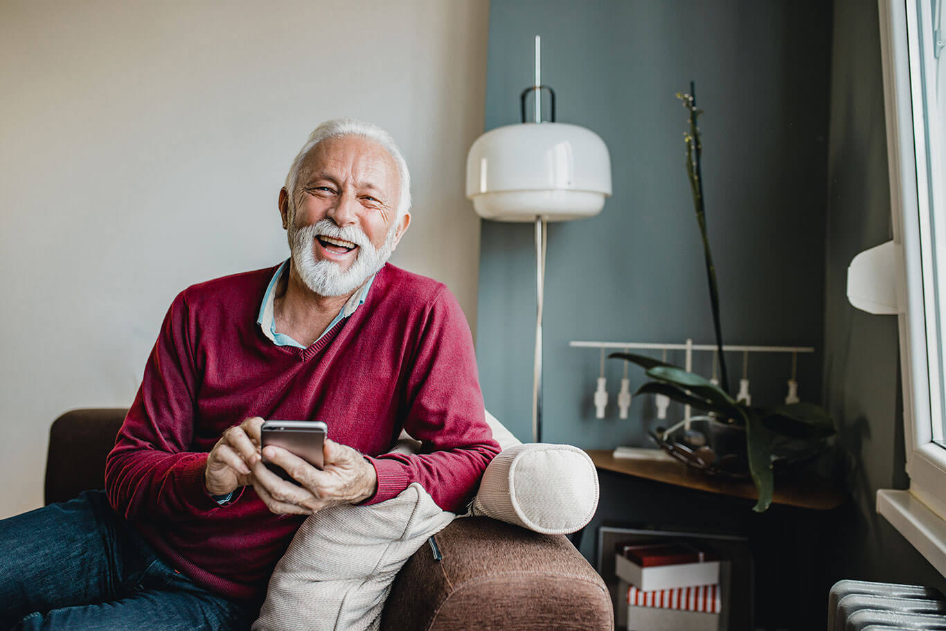 Man smiling using cell phone