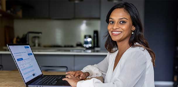 A physician uses a computer with two monitors to go over patient data