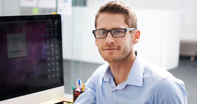 Man smiling at desk